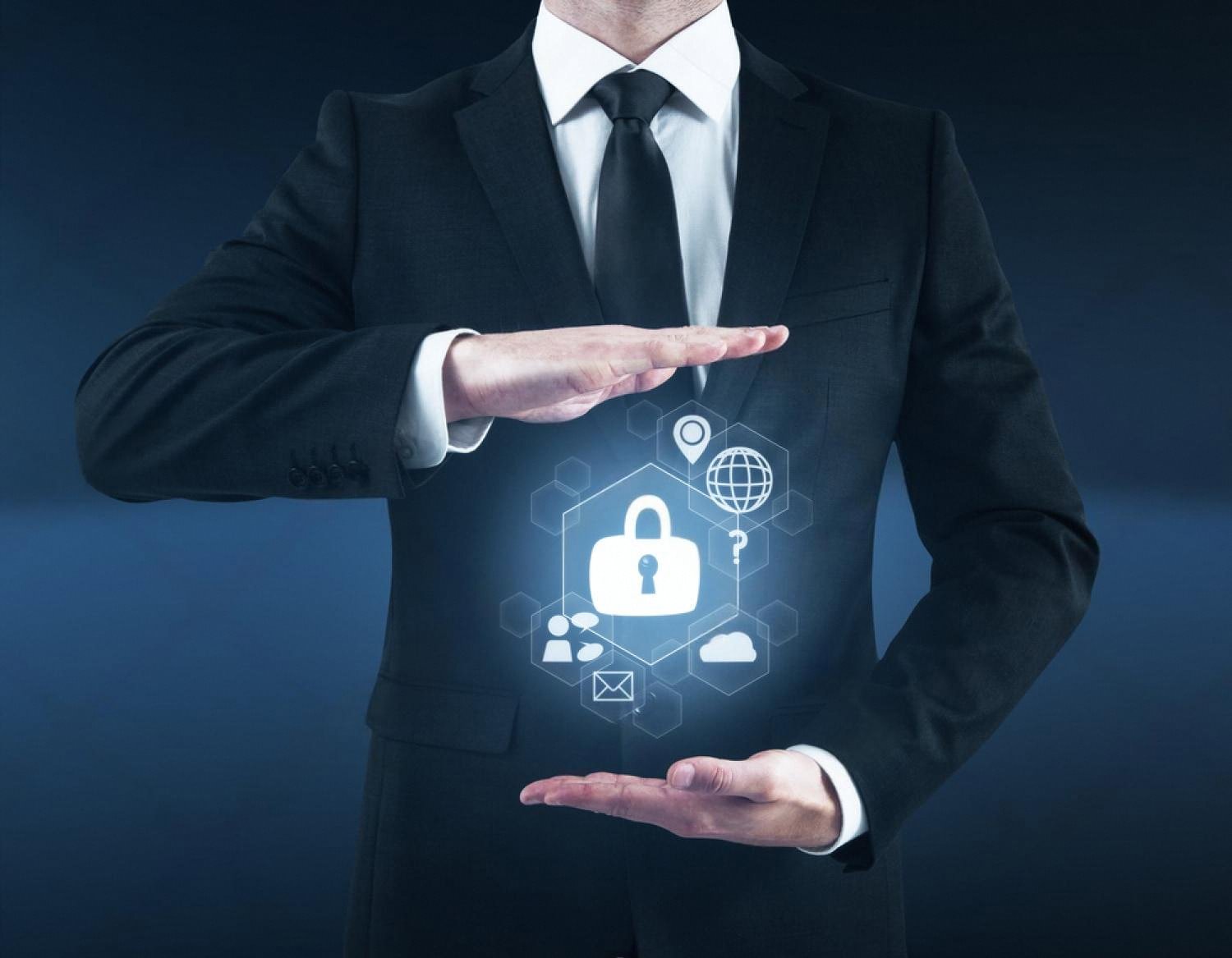 Businessman in suit holding a digital padlock shield representing cybersecurity protection for UAE companies