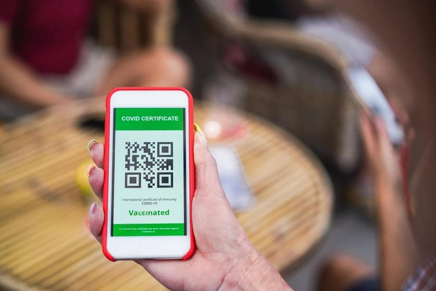 Hand holding a smartphone displaying a QR-coded digital appointment ticket used at a UAE tourist center